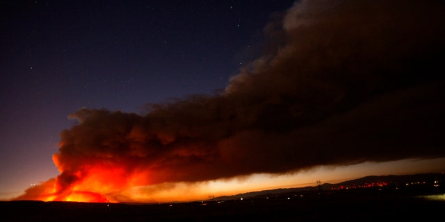The Lake Hughes fire sends a plume of smoke over Angeles National Forest on Wednesday, Aug. 12, 2020, north of Santa Clarita, Calif.