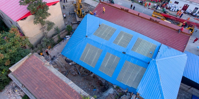 Rescue workers are seen near the site of a collapsed two-story restaurant in Xiangfen County of Linfen City, northern China's Shanxi Province, Saturday, Aug. 29, 2020. (Yang Chenguang/Xinhua via AP)