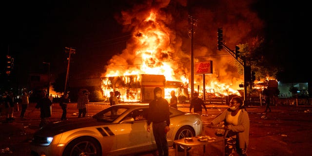 An AutoZone store burns as protesters gather outside of the Third Precinct in Minneapolis Thursday, May 28, 2020.  (Mark Vancleave/Star Tribune via AP)