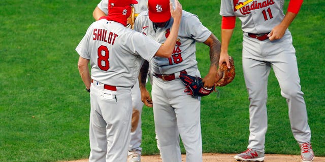 St. Louis Cardinals manager Mike Shildt (8) consoles pitcher Carlos Martinez on the cap as he pulls him following a solo home run by Minnesota Twins' Josh Donaldson in the fourth inning of a baseball game Tuesday, July 28, 2020, in Minneapolis. 