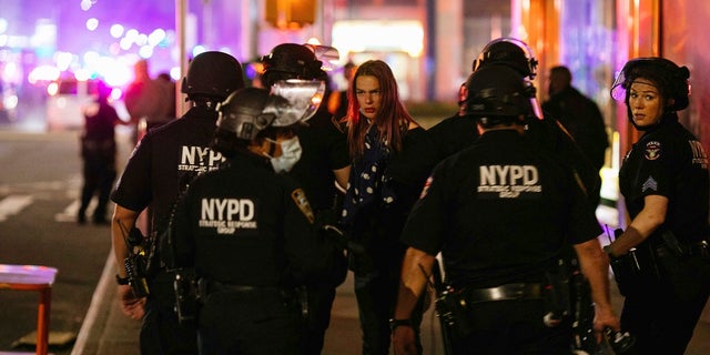 Nikki Stone is detained by police during protests May 31, in New York, against police brutality sparked by the death of George Floyd at the hands of police in Minneapolis. A Gallup poll released Wednesday found that 81% of Black Americans favor a police presence in their neighborhoods at current or increased levels. (AP Photo/Kevin Hagen)