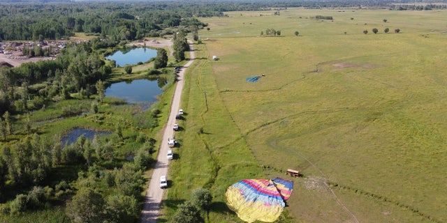 Two of three sightseeing balloons that crashed Monday, Aug. 3, 2020, are seen in an open area of Jackson Hole in western Wyoming. Between 16 and 20 people were hurt, officials said. (Brad Boner/Jackson Hole News&Guide via AP)