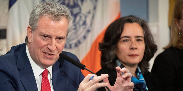 In this Wednesday, Feb. 26, 2020, file photo, Mayor Bill de Blasio, left, is shown with Dr. Oxiris Barbot, then-commissioner of the New York City Department of Health and Mental Hygiene, in New York. (AP Photo/Mark Lennihan, File)