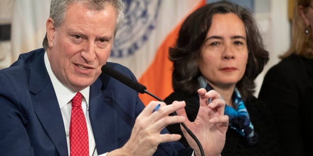 In this Wednesday, Feb. 26, 2020, file photo, Mayor Bill de Blasio, left, is shown with Dr. Oxiris Barbot, then-commissioner of the New York City Department of Health and Mental Hygiene, in New York. (AP Photo/Mark Lennihan, File)