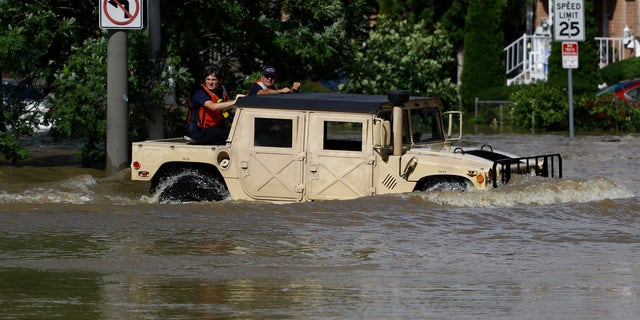 Philadelphia firefighters drive through a flooded neighborhood during Tropical Storm Isaias, Tuesday, Aug. 4, 2020, in Philadelphia.