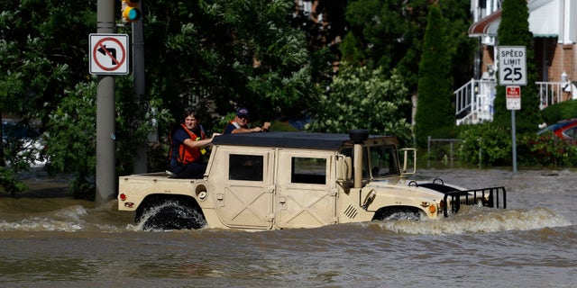 Philadelphia firefighters drive through a flooded neighborhood during Tropical Storm Isaias, Tuesday, Aug. 4, 2020, in Philadelphia.