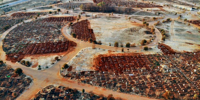 Recently filled graves are seen in the Olifantsveil Cemetery outside Johannesburg, South Africa, Wednesday Aug. 5, 2020. The frequency of burials in South Africa has significantly increased during the coronavirus pandemic, as the country became one of the top five worst-hit nation. New infection numbers around the world are a reminder that a return to normal life is still far from sight. 