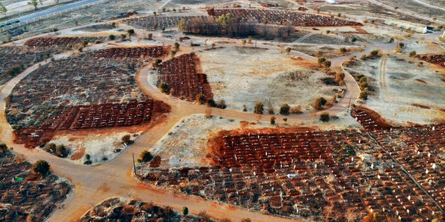 Recently filled graves are seen in the Olifantsveil Cemetery outside Johannesburg, South Africa, Wednesday Aug. 5, 2020. The frequency of burials in South Africa has significantly increased during the coronavirus pandemic, as the country became one of the top five worst-hit nation. New infection numbers around the world are a reminder that a return to normal life is still far from sight.