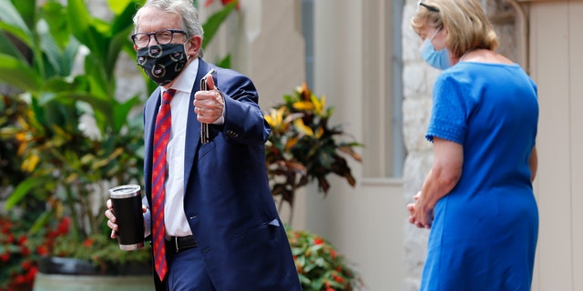 Ohio Governor Mike DeWine, left, and his wife Fran, walk into their residence after he tested positive for COVID-19 earlier in the day Thursday, Aug. 6, 2020, in Bexley, Ohio. (AP Photo/Jay LaPrete)