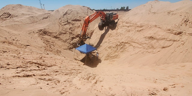 In this undated photo provided by U.S. Immigration and Customs Enforcement, excavation work continues at a site of an incomplete tunnel intended for smuggling, found stretching from Arizona to Mexico. (Courtesy of ICE via AP)