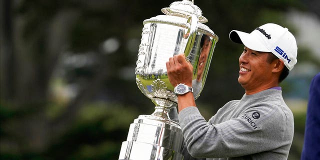 Collin Morikawa holds the Wanamaker Trophy after winning the PGA Championship golf tournament at TPC Harding Park Sunday, Aug. 9, 2020, in San Francisco.