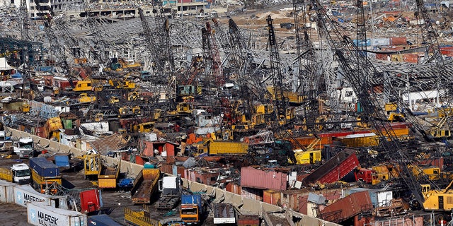 Rows of destroyed trucks are seen at the site of last week's explosion that hit the seaport of Beirut, Lebanon, Monday, Aug. 10, 2020. (AP Photo/Bilal Hussein)