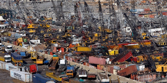 Rows of destroyed trucks are seen at the site of last week's explosion that hit the seaport of Beirut, Lebanon, Monday, Aug. 10, 2020. (AP Photo/Bilal Hussein)