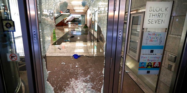 A door to the Block 37 retail building is shattered Monday, Aug. 10, 2020, after vandals struck overnight in Chicago's famed Loop. 