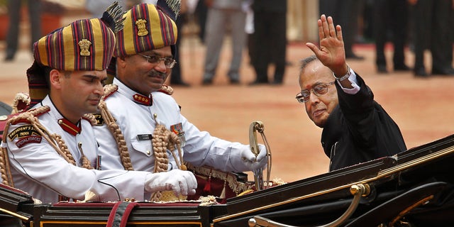 Pranab Mukherjee, right, arriving in a traditional horse-driven carriage to be sworn in as India's 13th president at the Presidential Palace, in New Delhi, in 2012.