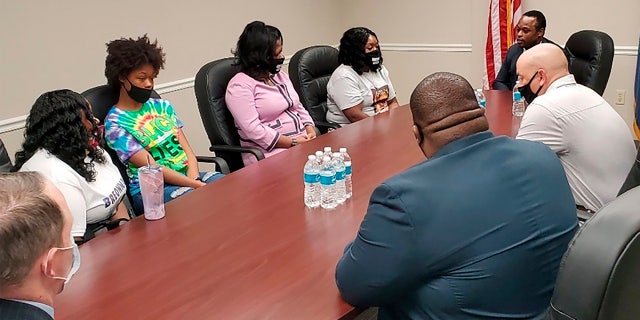 Tamika Palmer, far left, the mother of Breonna Taylor, and other family members meet with Kentucky Attorney General Daniel Cameron on Wednesday, Aug. 12, 2020, in Louisville, Ky. (Christopher 2X via AP)