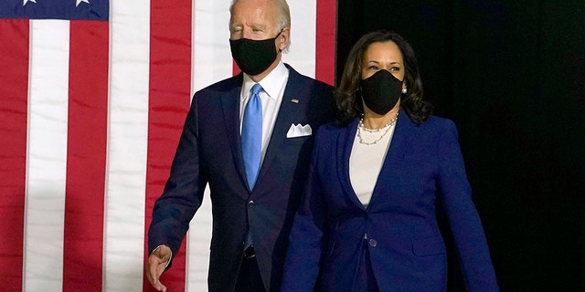 Democratic presidential candidate former Vice President Joe Biden and his running mate Sen. Kamala Harris, D-Calif., arrive to speak during a news conference at Alexis Dupont High School in Wilmington, Del., Wednesday, Aug. 12, 2020. (AP Photo/Carolyn Kaster)