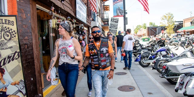 Bikers walk down Main Street during the 80th annual Sturgis Motorcycle Rally on Saturday, Aug. 15, 2020, in Sturgis, S.D. (Amy Harris/Invision/AP)