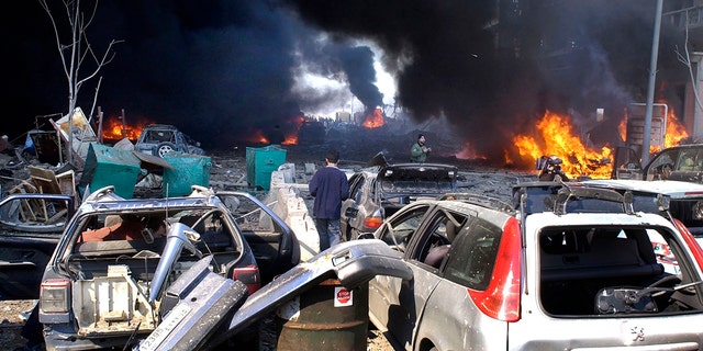 In this Feb. 14, 2005 file photo, destroyed vehicles litter the site of a massive bomb attack that tore through the motorcade of former Prime Minister Rafik Hariri in Beirut, Lebanon.  (AP Photo)