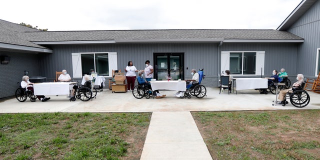 In this June 25, 2020, file photo, residents at the Southern Pines nursing home are separated and wear face coverings during their daily bingo game in Warner Robins, Ga. (AP Photo/John Bazemore, File)