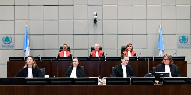 Presiding Judge, Judge David Re, back centre, with Judge Janet Nosworthy, left, and Judge Micheline Braidy, during a session of the United Nations-backed Lebanon Tribunal in Leidschendam, Netherlands Tuesday Aug. 18, 2020, where it is scheduled to hand down it's judgement in the case against four men being tried for the bombing that killed former Lebanon Prime Minister Rafik Hariri and 21 other people. The U.N.-backed tribunal in the Netherlands is to deliver verdicts in the trial held in absentia of four members of the militant Lebanese Hezbollah group accused of involvement in the truck bomb assassination of former Lebanese Prime Minister Rafik Hariri in 2005. (Piroschka Van De Wouw/Pool via AP)
