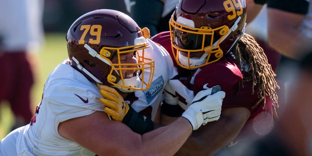Washington offensive tackle Paul Adams (79) and defensive end Chase Young (99) during practice at the team's NFL football training facility, Tuesday, Aug. 18, 2020, in Ashburn, Va. (AP Photo/Alex Brandon)