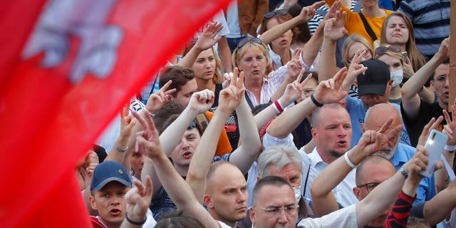 Belarusian opposition supporters shout slogans during a protest rally in front of the government building at Independent Square in Minsk, Belarus, Tuesday, Aug. 18, 2020.