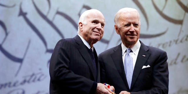 Sen. John McCain, R-Ariz., receives the Liberty Medal from Chair of the National Constitution Center's Board of Trustees, former Vice President Joe Biden, in Philadelphia.