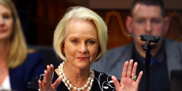 Cindy McCain waves to the crowd after being recognized by Republican Arizona Gov. Doug Ducey during his State of the State address.