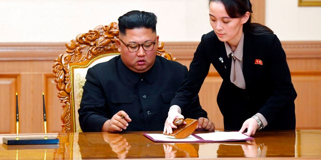 FILE: Kim Yo Jong, right, helps her brother North Korean leader Kim Jong Un sign a joint statement following the summit with South Korean President Moon Jae-in at the Paekhwawon State Guesthouse in Pyongyang, North Korea.Â 