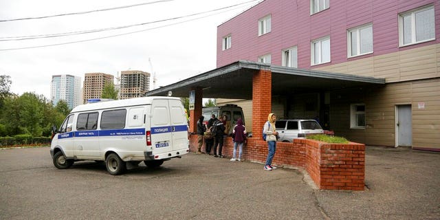 An ambulance is parked outside the hospital intensive care unit where Alexei Navalny is hospitalized in Omsk, Russia, Thursday, Aug. 20, 2020.
