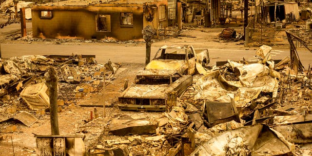 Scorched homes and vehicles fill Spanish Flat Mobile Villa following the LNU Lightning Complex fires in unincorporated Napa County, Calif., on Aug. 20. The fire destroyed dozens of homes at the mobile home park with only a handful that remained standing. Fire crews across the region scrambled to contain dozens of wildfires sparked by lightning strikes. (AP Photo/Noah Berger)