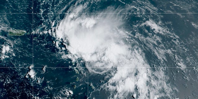 This satellite image released by the National Oceanic and Atmospheric Administration (NOAA) shows Tropical Storm Laura in the North Atlantic Ocean, Friday, Aug. 21, 2020. Laura formed Friday in the eastern Caribbean and forecasters said it poses a potential hurricane threat to Florida and the U.S. Gulf Coast. A second storm also may hit the U.S. after running into Mexico's Yucatan Peninsula. (NOAA via AP)