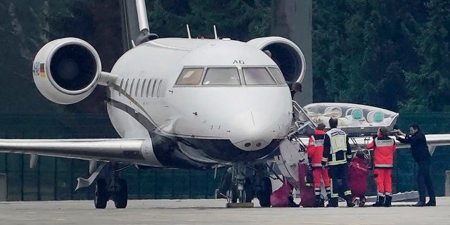A stretcher is taken from special aircraft with the Kremlin critic Alexei Navalny on board at Tegel Airport in Berlin, Germany, Saturday, Aug.22, 2020. The Russian opposition member has been in a coma since Thursday and is on artificial respiration. ( Michael Kappeler/dpa via AP)