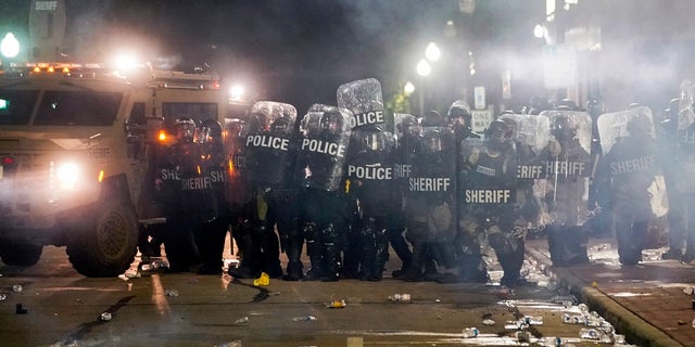 Police clash with protesters near the Kenosha County Courthouse on Monday. (AP Photo/Morry Gash)