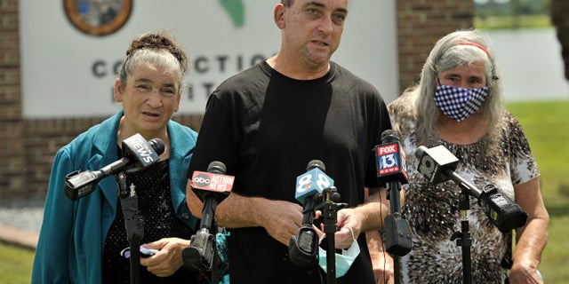 Former inmate Robert DuBoise, 56, meets reporters with his sister Harriet, left, and mother Myra, right, outside the Hardee County Correctional Institute after serving 37 years in prison, when officials discovered new evidence that proved his innocence Thursday, Aug. 27, 2020, in Hardee County, Fla. (AP Photo/Steve Nesius)