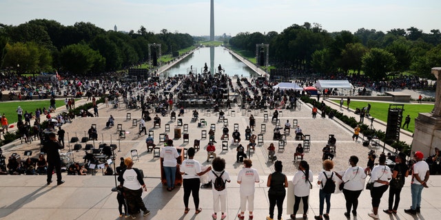 Demonstrators gather at the Lincoln Memorial as final preparations are made for the March on Washington, Friday Aug. 28, 2020, at the Lincoln Memorial in Washington, on the 57th anniversary of the Rev. Martin Luther King Jr.’s “I Have A Dream” speech. (Olivier Douliery/Pool via AP)
