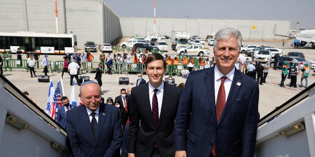 Israeli National Security Advisor Meir Ben-Shabbat, left, U.S. President Donald Trump's senior adviser Jared Kushner, center, and U.S. National Security Advisor Robert O'Brien, right, board the Israeli flag carrier El Al's airliner as they fly to Abu Dhabi for talks meant to put final touches on the normalization deal between the United Arab Emirates and Israel, at Ben-Gurion International Airport, near Tel Aviv, Israel Monday, Aug. 31, 2020. (Nir Elias/Pool Photo via AP)