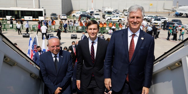Israeli National Security Advisor Meir Ben-Shabbat, left, U.S. President Donald Trump's senior adviser Jared Kushner, center, and U.S. National Security Advisor Robert O'Brien, right, board the Israeli flag carrier El Al's airliner as they fly to Abu Dhabi for talks meant to put final touches on the normalization deal between the United Arab Emirates and Israel, at Ben-Gurion International Airport, near Tel Aviv, Israel Monday, Aug. 31, 2020. (Nir Elias/Pool Photo via AP)