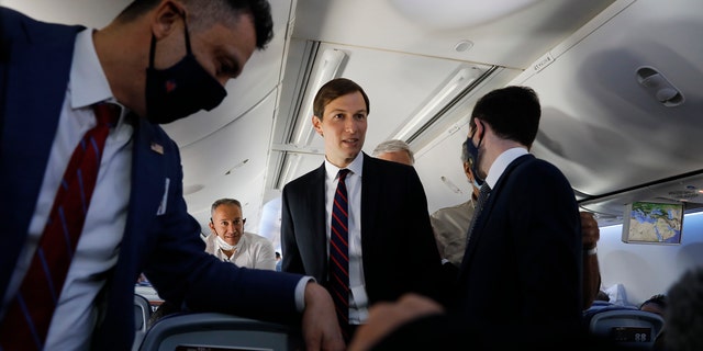 U.S. President Donald Trump's senior adviser Jared Kushner, center, speaks with passengers during a flight on an Israeli El Al plane bound for Abu Dhabi, United Arab Emirates, Monday, Aug. 31, 2020. The plane carrying a delegation of Israeli and American officials landed in Abu Dhabi after flying in from Israel in the first-ever direct commercial passenger flight to the UAE. The Israeli flag carrier’s flight Monday marks the implementation of the historic U.S.-brokered deal to normalize relations between the two nations. (Nir Elias/Pool Photo via AP)