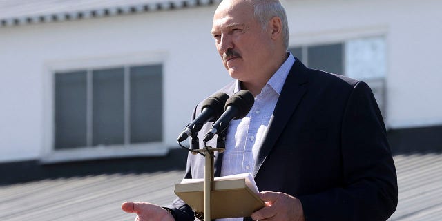 Belarusian President Alexander Lukashenko addresses workers of the Minsk Wheel Tractor Plant in Minsk, Belarus, on Monday. Several thousand factory workers have taken to the streets of Minsk demanding the resignation of authoritarian Belarusian President Alexander Lukashenko. (Nikolai Petrov/BelTA Pool Photo via AP)