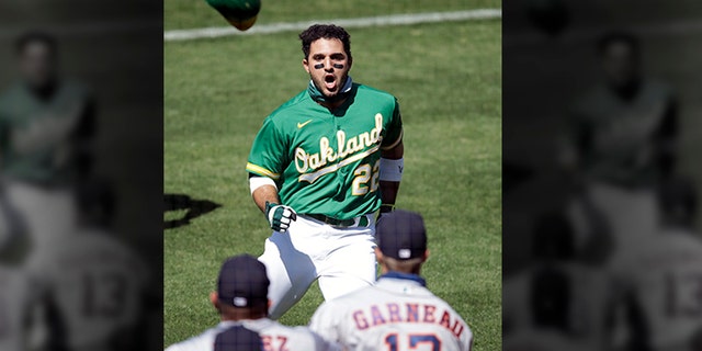 Oakland Athletics' Ramon Laureano (22) charges the Houston Astros dugout after being hit by a pitch thrown by Astros' Humberto Castellanos in the seventh inning of a baseball game Sunday, Aug. 9, 2020, in Oakland, Calif. 