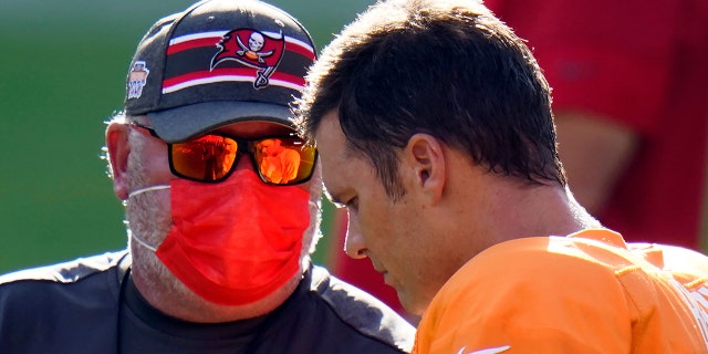 Tampa Bay Buccaneers head coach Bruce Arians talks to quarterback Tom Brady (12) during an NFL football training camp practice Friday, Aug. 28, 2020, in Tampa, Fla. (AP Photo/Chris O'Meara)