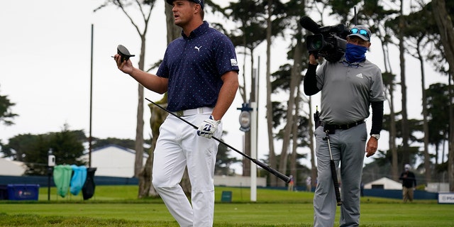 Bryson DeChambeau holds his broken driver on the seventh hole during the first round of the PGA Championship golf tournament at TPC Harding Park Thursday, Aug. 6, 2020, in San Francisco. (AP Photo/Jeff Chiu)