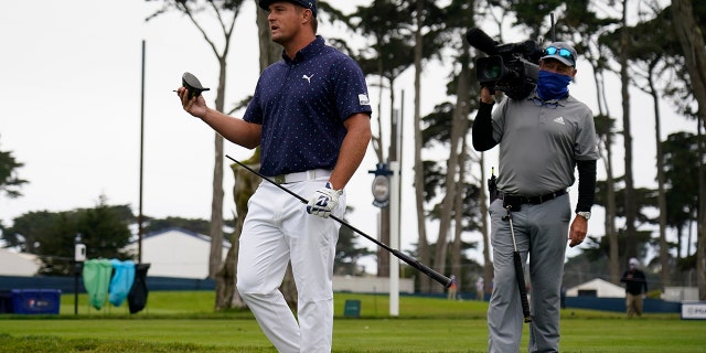 Bryson DeChambeau holds his broken driver on the seventh hole during the first round of the PGA Championship golf tournament at TPC Harding Park Thursday, Aug. 6, 2020, in San Francisco. (AP Photo/Jeff Chiu)