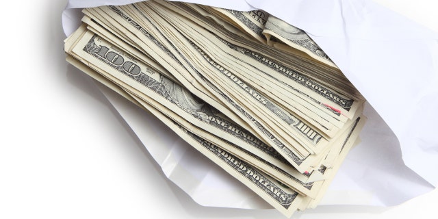 Man charged with federal wire fraud for silver dollar scam 3 CashEnvelopeiStock