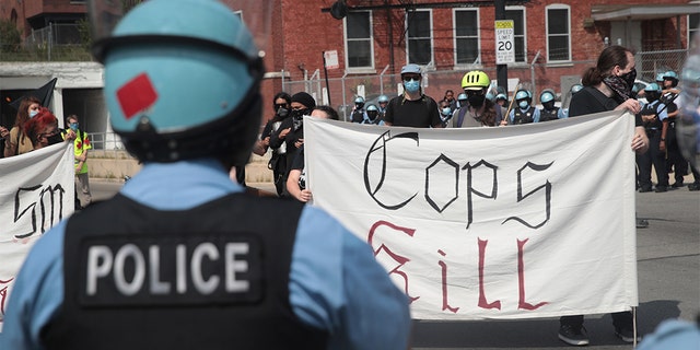 Police stand guard as pro and anti-police demonstrators gather outside of the Homan Square police station on August 15, 2020 in Chicago, Illinois. (Photo by Scott Olson/Getty Images)