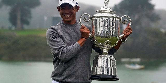 Collin Morikawa holds the Wanamaker Trophy after winning the PGA Championship golf tournament at TPC Harding Park Sunday, Aug. 9, 2020, in San Francisco. (AP Photo/Jeff Chiu)