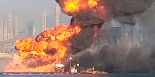Coast Guard crews respond to a dredge on fire in the Port of Corpus Christi Ship Channel, Aug. 21, in Corpus Christi, Texas. Authorities say several people have been hospitalized after an explosion at the Texas port when a dredging vessel hit a natural gas pipeline in the water. (U.S. Coast Guard via AP)
