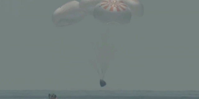 In this frame grab from NASA TV, the SpaceX capsule splashes down Sunday, Aug. 2, 2020 in the Gulf of Mexico.